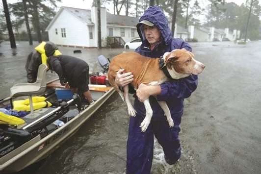Volunteers help rescue residents and their pets from their flooded homes during Hurricane Florence in New Bern, North Carolina.