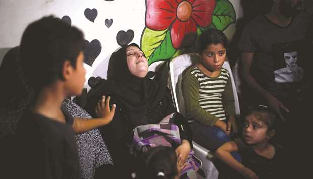 The mother of 12-year-old Palestinian boy Shadi Abdel Aal, who was killed by Israeli forces during a protest at the  border fence, mourns during his funeral in the northern Gaza Strip, yesterday.