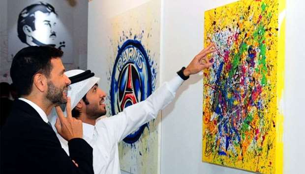 Tamim Al Majd artist Ahmed al-Maadheed with Italian ambassador Pasquale Salzano at the opening of '5/6' exhibition. PICTURE: Nasar T K.
