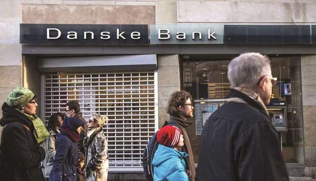 Pedestrians pass a Danske Bank branch in Copenhagen. Danske Bank has become such a volatile stock that Nasdaq is now resorting to a seldom-used intervention tool to try to stop market makers from walking away.