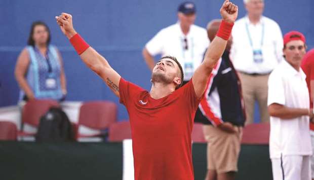 Croatiau2019s Borna Coric raises his arms in triumph after winning against Frances Tiafoe of the US in the Davis Cup World Group semi-final in Zadar, Croatia, yesterday. (Reuters)