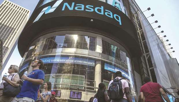 Pedestrians walk past the Nasdaq MarketSite in New York (file). Members of Nasdaqu2019s Nordic commodities exchange have fully replenished vital clearing house contingency funds that were lost last week when a single Norwegian trader defaulted, according to the exchange operator.