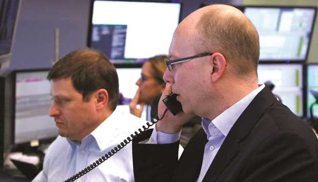 Traders work at the Frankfurt Stock Exchange. The DAX 30 was down 0.2% to 12,096.41 points yesterday.
