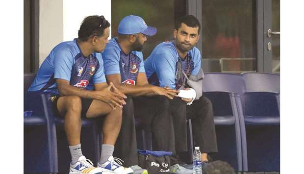 Bangladeshu2019s Tamim Iqbal (right) with his injured left hand looks on during the Asia Cup match against Sri Lanka on Saturday. (AFP)