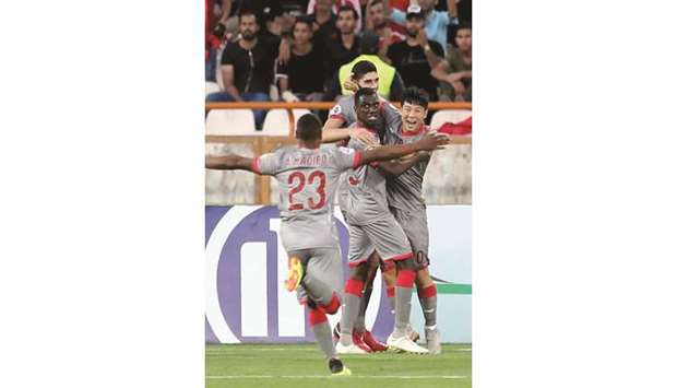 Al Duhailu2019s players congratulate Karim Boudiaf after he scored against Persepolis at the Azadi Stadium in Tehran yesterday.