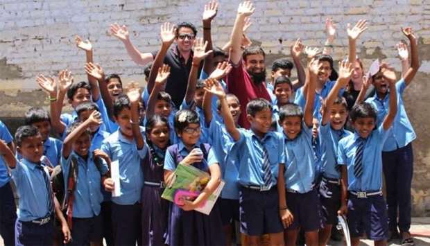 Dr Mohamed al-Hajri and Dr Faisal Naqadan with childrenrnrn