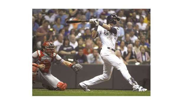 Milwaukee Brewers left fielder Christian Yelich (right) hits a 2-run homer in the fifth inning against the Cincinnati Reds at Miller Park in Milwaukee on Monday. (USA TODAY Sports)