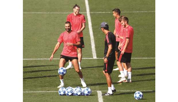 Real Madridu2019s Karim Benzema and Gareth Bale (back) with teammates during a training session yesterday.