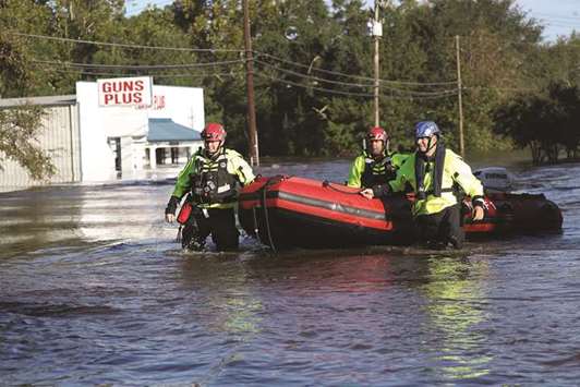 Members of New York Urban Search and Rescue Task Force One work in an area flooded with waters from the Little River in Spring Lake, North Carolina.