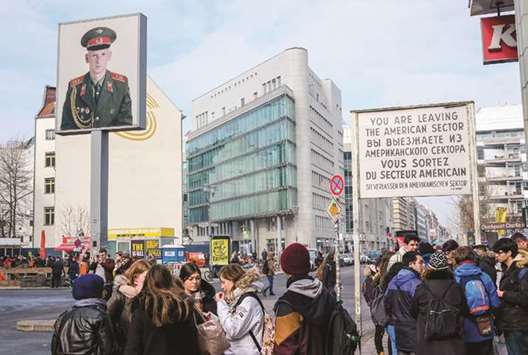 TOURISTY: Tourists gather near a copy of the original sign at Checkpoint Charlie warning that u2018You are now leaving the American sector.u2019