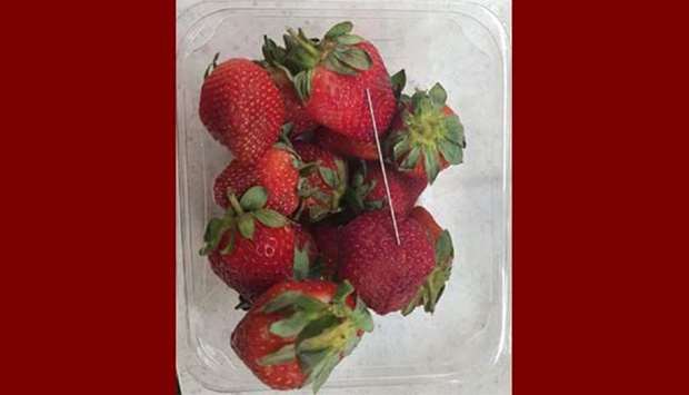 A thin piece of metal is seen among a punnet of strawberries in Gladstone, Queensland.