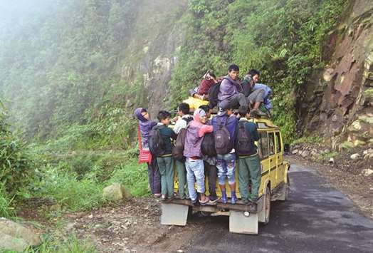 Villagers and school children are seen on an overcrowded vehicle as they travel to Kongthong village, in East Khasi Hills district in Meghalaya.