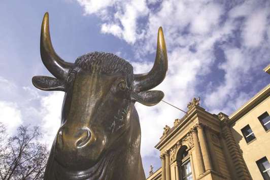  A statue of a bull is seen outside the Frankfurt Stock Exchange. The DAX 30 ended with a 0.5% gain at 12,157.67 points yesterday.