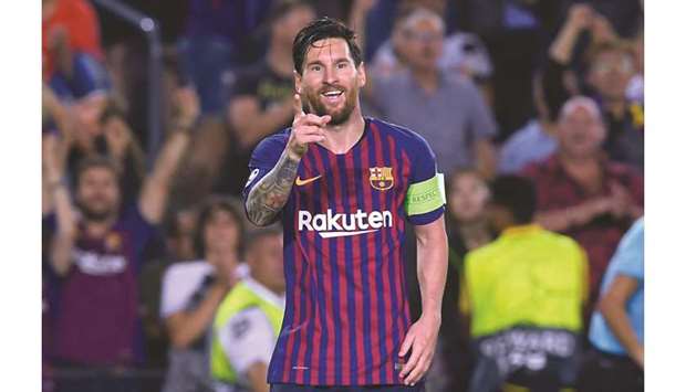 Barcelonau2019s Argentinian forward Lionel Messi celebrates after scoring his third goal against PSV Eindhoven at the Camp Nou stadium in Barcelona yesterday.