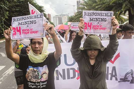 Groups stage a protest as they march to the Sofitel Philippine Plaza in Pasay City yesterday, urging the government to stop large and small-scale mining.