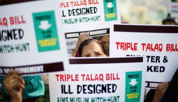 Muslim women hold placards during a protest against a bill passed by India's lower house of Parliament that aims at prosecuting Muslim men who divorce their wives through the ,triple talaq,, in New Delhi in January this year. File picture