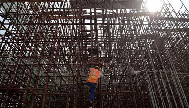 A worker climbs on steel bars at a subway construction site in Chengdu, Sichuan province, last month.