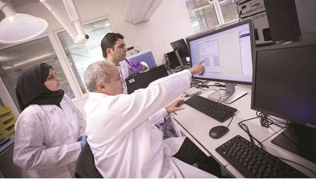 Some of the researchers at one of the labs at QBRI.