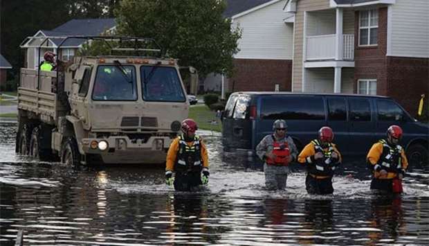 Search and rescue task force members help evacuate people from their homes in Fayetteville, North Carolina on Tuesday.