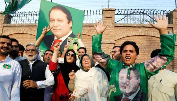 Supporters of former Prime Minister Nawaz Sharif react as they celebrate following the court's decision in Peshawar, Pakistan.