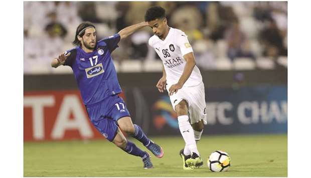Al Saddu2019s Akram Afif (left) vies for the ball with Esteghlalu2019s Humam Tarek during their AFC Champions League quarter-final at the Jassim Bin Hamad Stadium in Doha on Monday. (AFP)