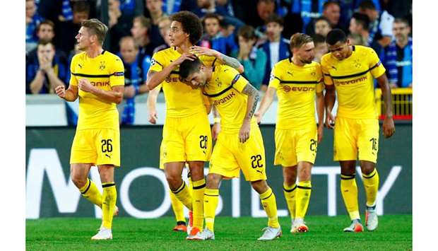 Borussia Dortmundu2019s Christian Pulisic (No 22) celebrates with teammates after scoring against Brugge in their Champions League match in Bruges. (Reuters)