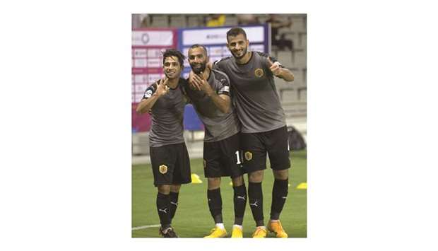 In this August 4, 2018, picture, Qatar SCu2019s Hussein Ali al-Saedi (left), who scored two goals in the match, celebrates the victory over Al Gharafa with his teammates.