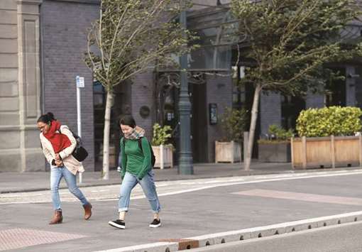 Two women walk on a windy day in Dundee, Scotland, yesterday.