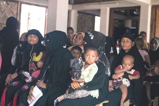 Rohingya women wait to be seen by a doctor at a clinic for pregnant women run by COAST, a local NGO.