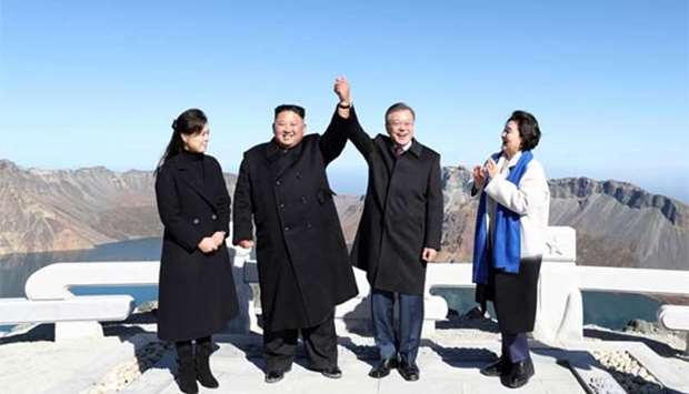 North Korean leader Kim Jong Un and his wife Ri Sol Ju (left) pose with South Korean President Moon Jae-in and his wife Kim Jung-sook on top of Mount Paektu on Thursday after their summit.