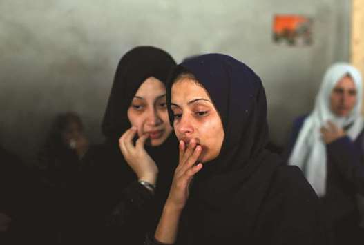 Relatives of Palestinian Ahmed Omar, who was killed during a protest near the Israeli Erez crossing with Gaza, mourn during his funeral in Al-Shati refugee camp in Gaza City, yesterday.