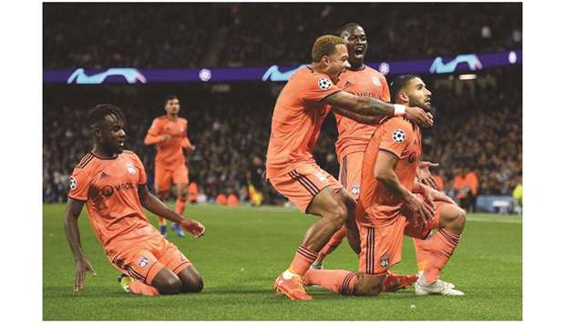 Lyonu2019s Nabil Fekir (right) celebrates with teammates after scoring against Manchester City in the Champions League in Manchester on Wednesday night. (AFP)