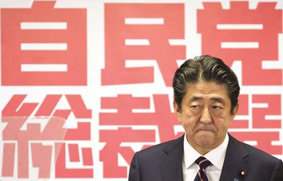 Japanu2019s Prime Minister Shinzo Abe, who is also the ruling Liberal Democratic Party (LDP) leader, attends a news conference after he won the ruling party leadership vote at the partyu2019s headquarters in Tokyo, Japan, yesterday.