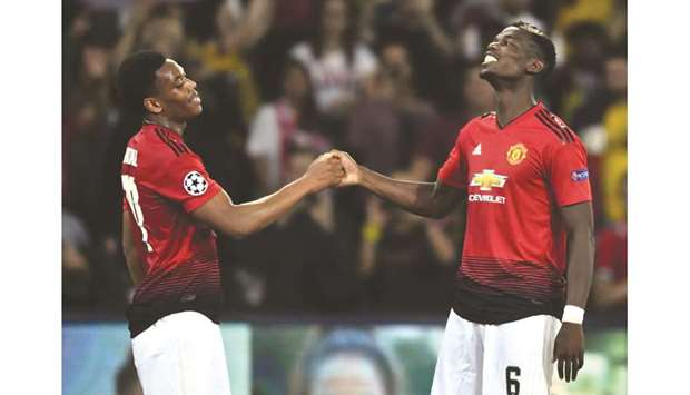 Manchester Unitedu2019s Paul Pogba (right) and Anthony Martial celebrate after their win over Young Boys in the Champions League in Bern, Switzerland. (AFP)