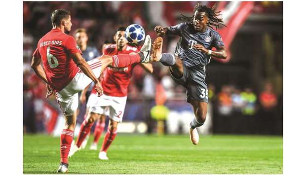 Benficau2019s defender Ruben Dias (left) vies for the ball with Bayern Munichu2019s midfielder Renato Sanches  during the UEFA Champions League match in Lisbon on Wednesday night. (AFP)