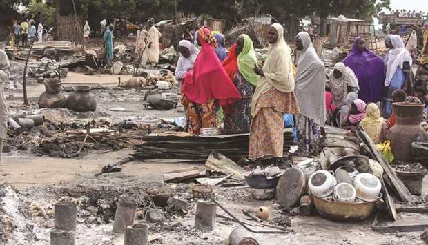 Women sift through the remains of a market blown up during an attack in Amarwa, some 20km from Borno state capital Maiduguri.