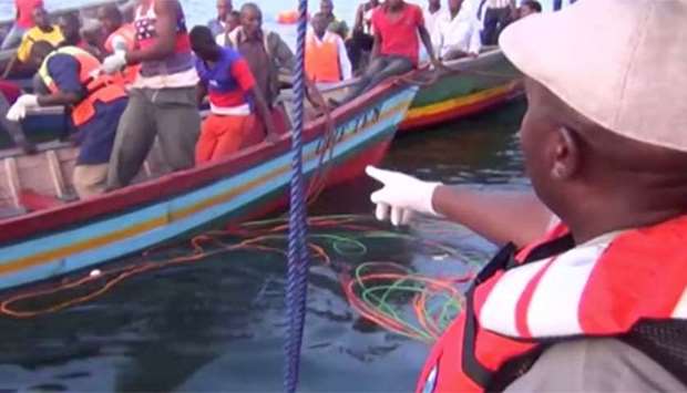Rescue workers are seen at the scene of the ferry disaster in Lake Victoria on Friday.