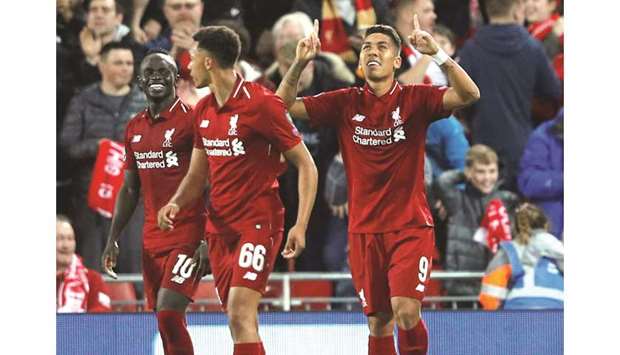 Liverpoolu2019s Roberto Firmino (right) celebrates after scoring a goal during the Champions League Group C match against Paris Saint-Germain in Liverpool on Tuesday. (Reuters)