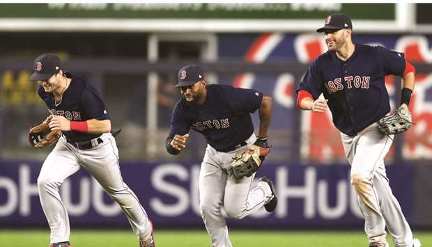 Boston Red Soxu2019s Andrew Benintendi (left), Jackie Bradley Jr. (centre) and Oscar Hernandez celebrate after their win over New York Yankees on Thursday night. (USA TODAY Sports)