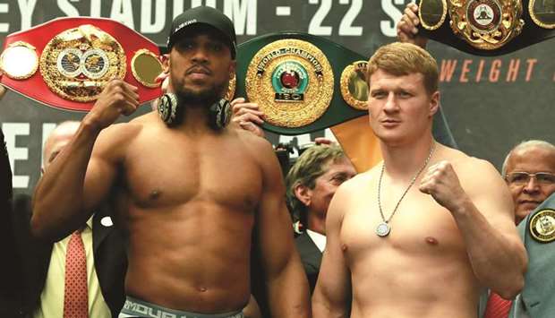 Anthony Joshua (left) and Alexander Povetkin pose for a photograph during their weigh-in in London yesterday. (Reuters)