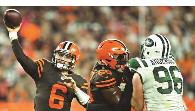 Cleveland Browns quarterback Baker Mayfield (left) throws a pass during the NFL game against New York Jets on Thursday. (USA TODAY Sports)