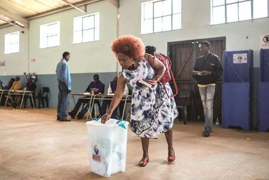 An elderly Swazi woman casts her ballot during eSwatini parliamentary elections, at the Mahlanya school in Lobamba Lomdzala.