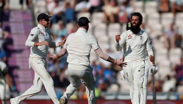 England's Moeen Ali celebrates taking the wicket of India's Ajinkya Rahane.