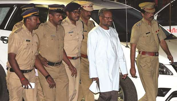 Bishop Franco Mulakkal is escorted by police outside a crime branch office on the outskirts of Kochi yesterday.