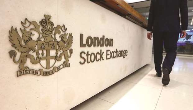 A visitor passes a sign at the London Stock Exchange Group headquarters. The FTSE 100 was 1.7% up at 7,490.23 points at close yesterday.