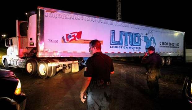 A trailer carrying more than 100 bodies of unidentified people is driven through the streets of Guadalajara after being taken from the winery of the prosecutor's in Guadalajara and transferred to the Jaliscience Institute of Forensic Sciences in Tlaquepaque, on September 17.