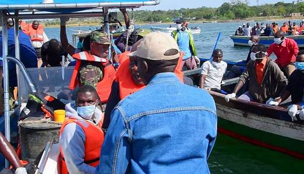 Rescuers search to retrieve bodies from the water after a ferry overturned off the shores of Ukerewe Island on Lake Victoria, Tanzania yesterday.