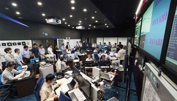 Institute of Space and Astronautical Science (ISAS) of Japan Aerosapace Exploration Agency (JAXA) researchers and employees work at a control room to operate the Hayabusa2 mission in Sagamihara
