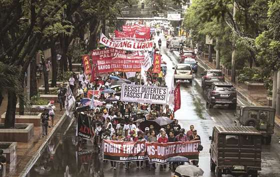 Protesters march on the streets to commemorate the 46th anniversary of the declaration of martial law by the late dictator Ferdinand Marcos in Manila, yesterday.