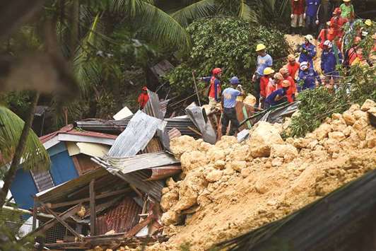 Rescuers search for survivors at the landslide site in Naga City, on the popular tourist island of Cebu.